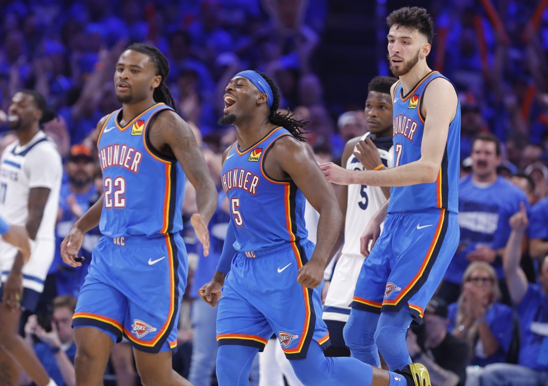 Thunder players Cason Wallace, Lu Dort, and Chet Holmgren celebrate a play against the Timberwolves in the 2024-25 NBA Playoffs.