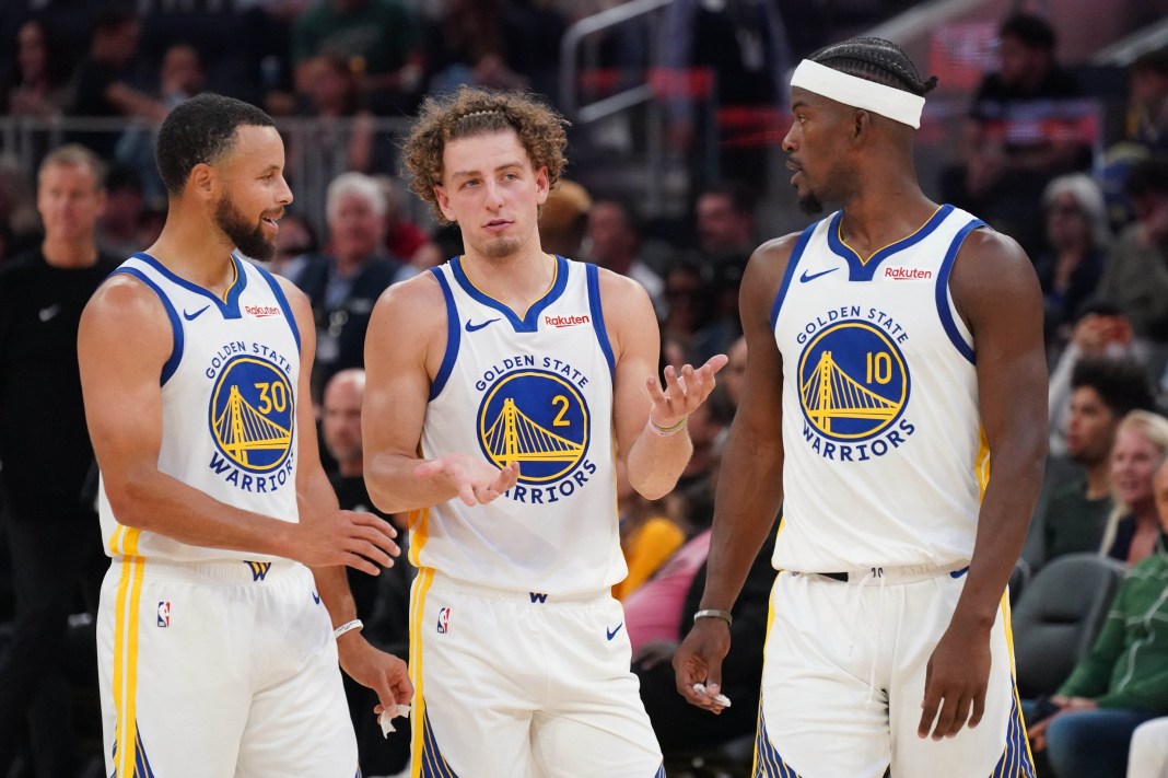 Warriors star Stephen Curry talks to Brandin Podziemski and Jimmy Butler during the 2025-26 NBA preseason.